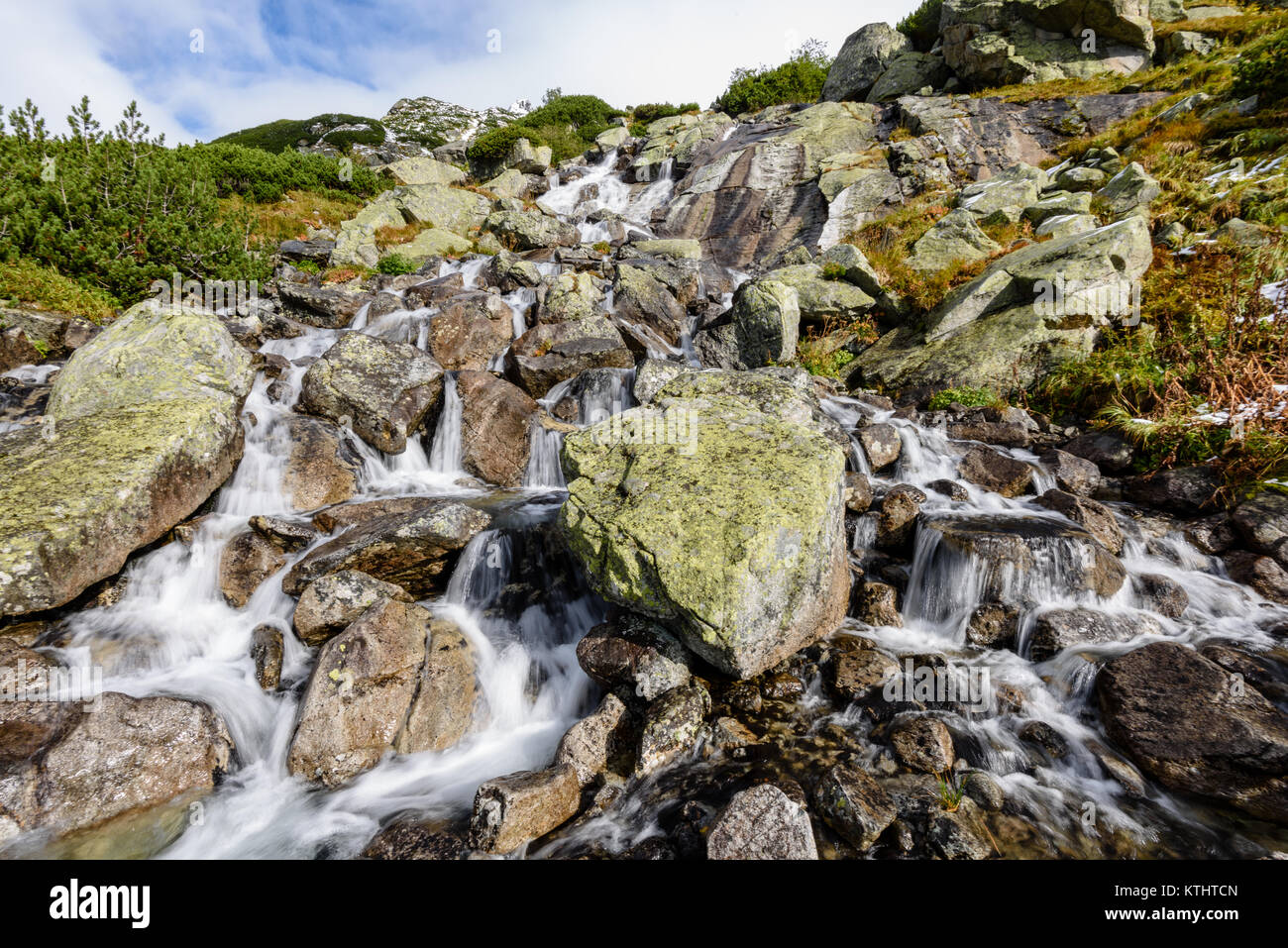 large Waterfall from ravine in autumn, long exposure, in mountain river ...