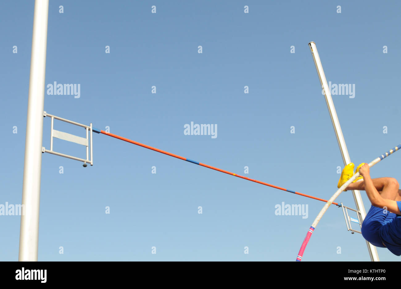 Pole vaulting. An Athlete in the middle of the vaulting phase during an