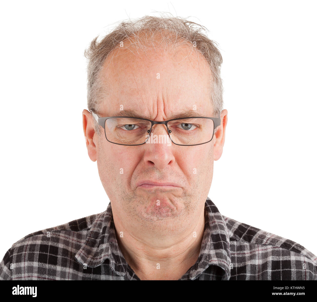 This is a portrait of a grumpy middle aged man. Stock Photo