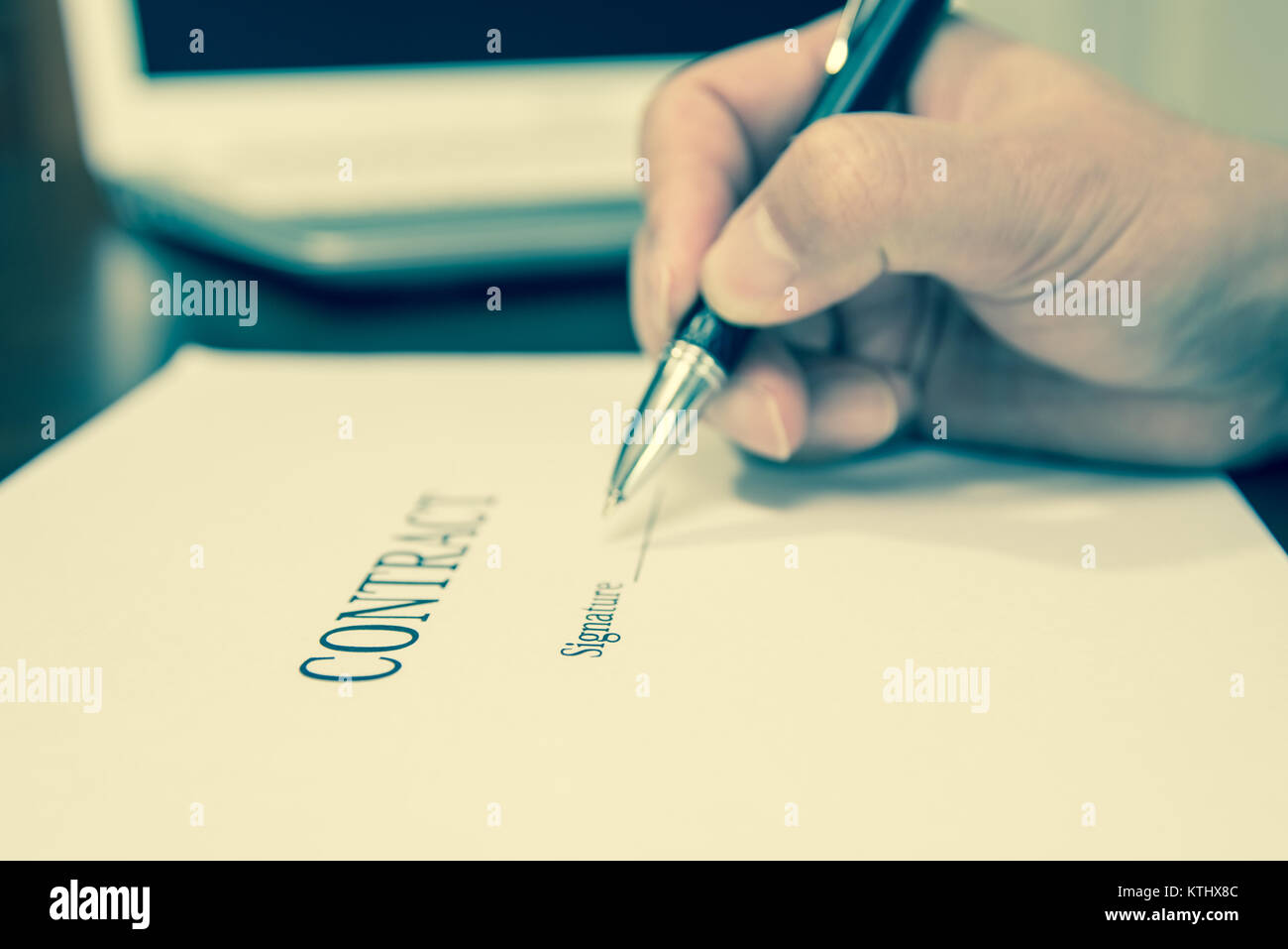 A concept of signing a contract holding a pen Stock Photo - Alamy