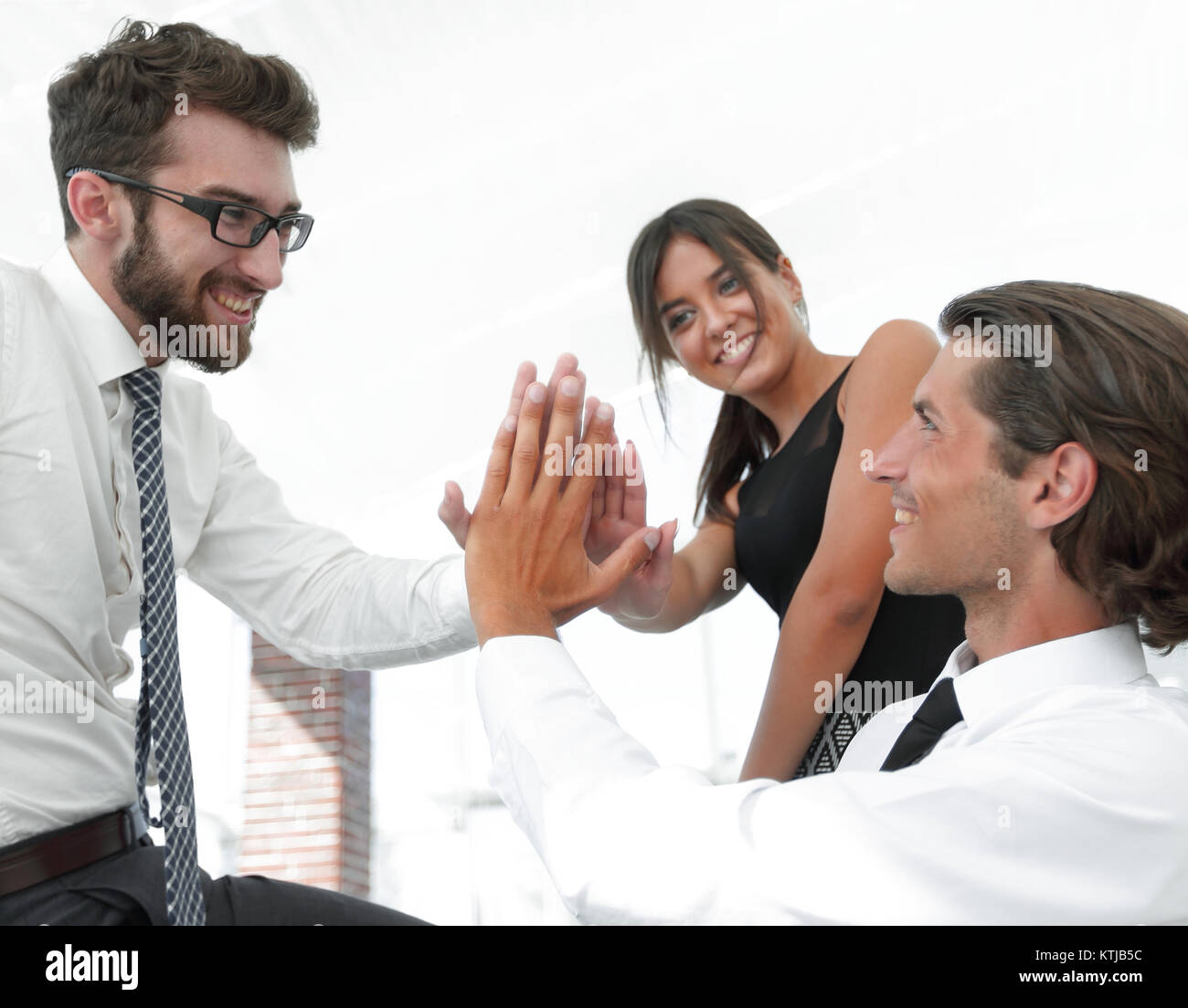members of the business team give each other high five Stock Photo - Alamy