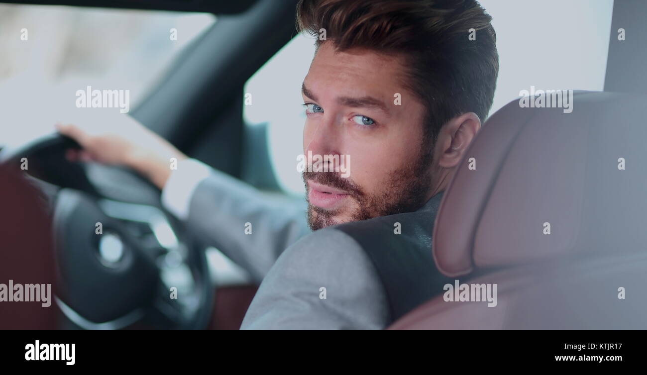 Portrait of an handsome smiling business man driving his car Stock ...