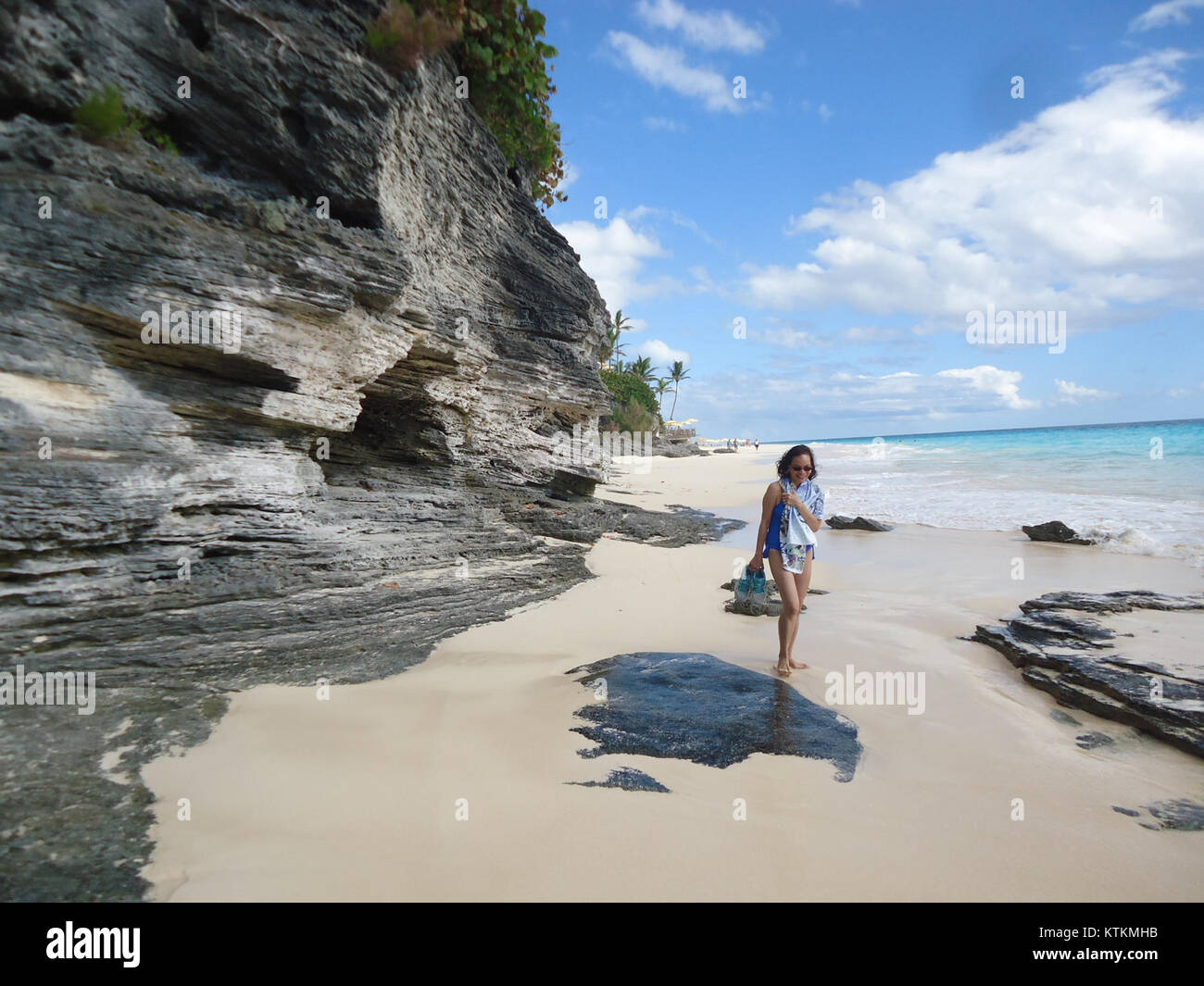 This image depicts the scenic Bermuda coastline with rocks, sand, and ...