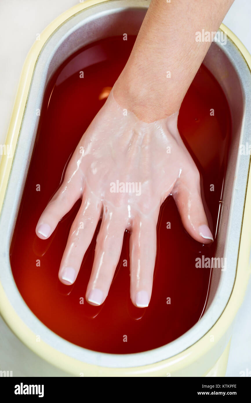 Process paraffin treatment of female hands in beauty salon Stock Photo