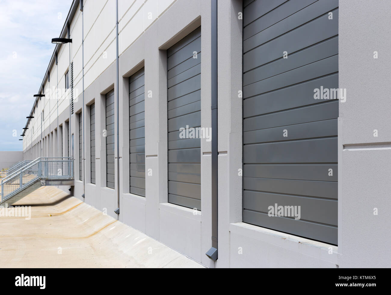 New construction warehouse loading dock white walls gray metal sliding
