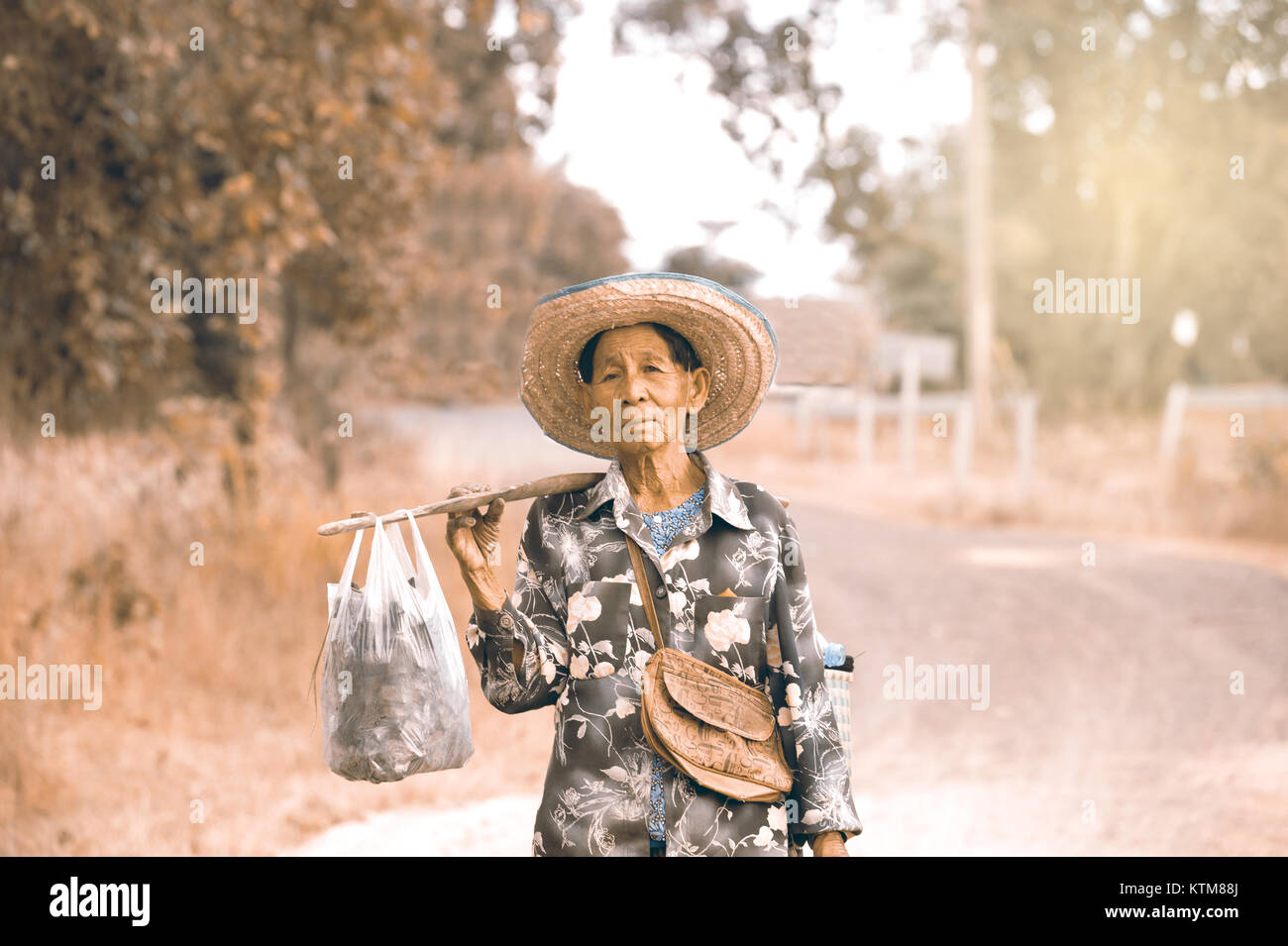 UBON RATCHATHANI THAILAND - JANUARY 16,2017 : Unidentified Elderly grandmother walking to home.She had to take this route every day . Stock Photo