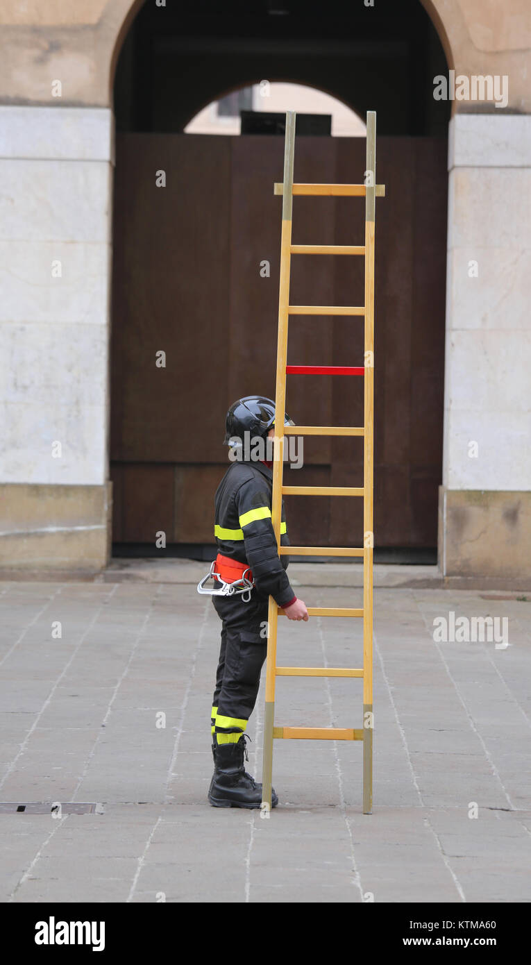 fireman with long wooden ladder training Stock Photo Alamy