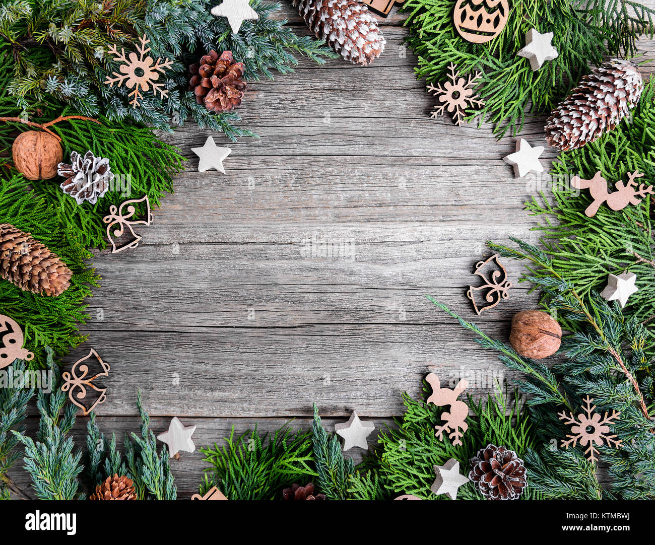 Christmas tree and nuts on wooden boards. Stock Photo