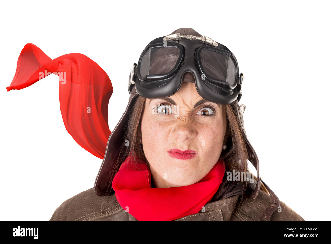 Funny girl with freckles wearing helmet, goggles and a red scarf Stock