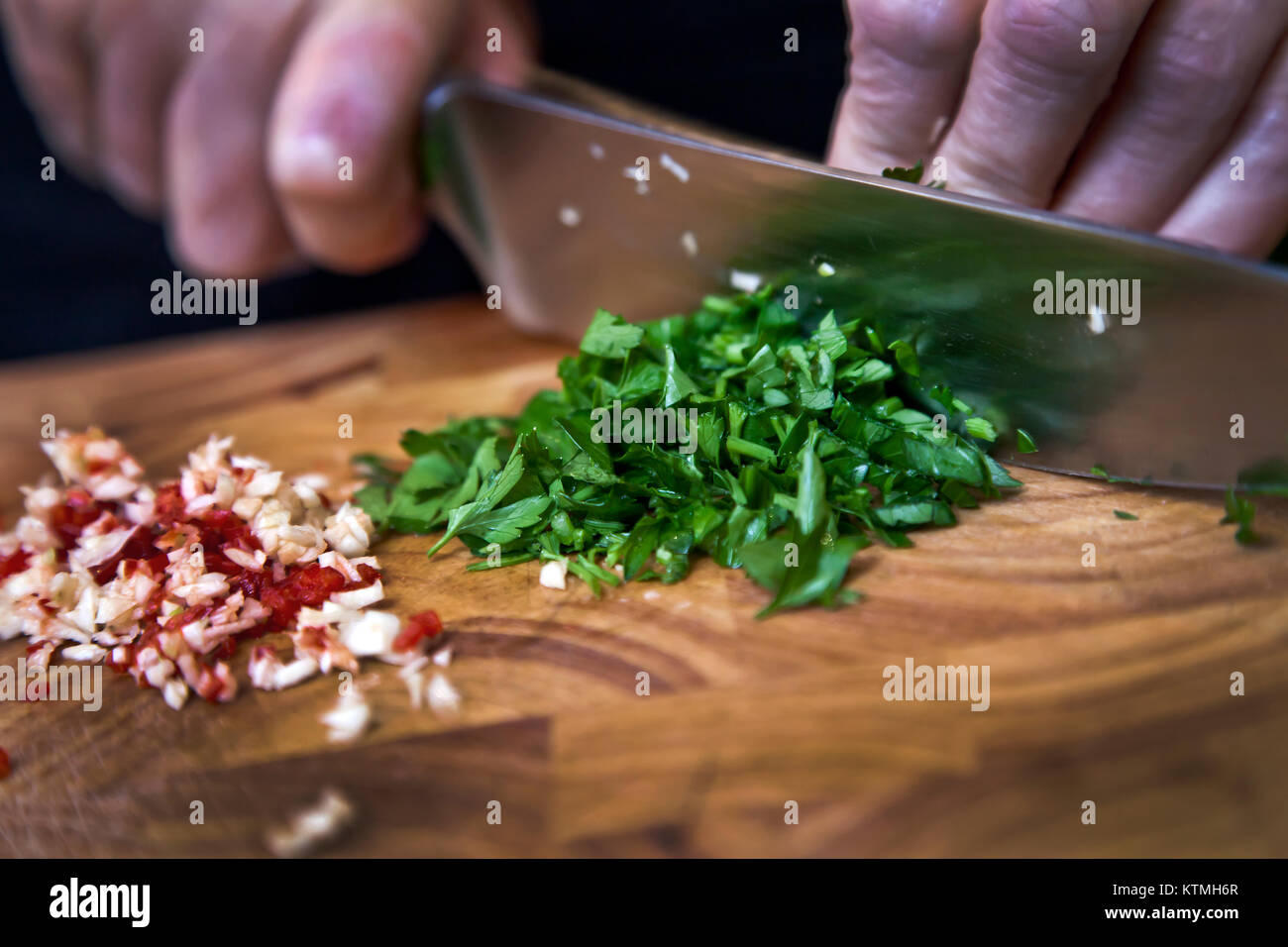 Food preparation - dicing Coriander on chopping board Stock Photo