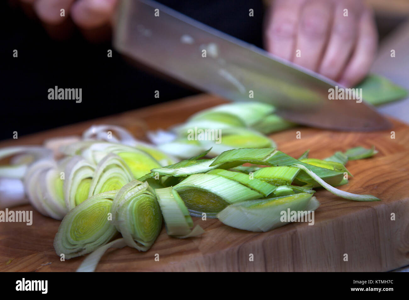 Food preparation slicing leeks on chopping board Stock Photo Alamy