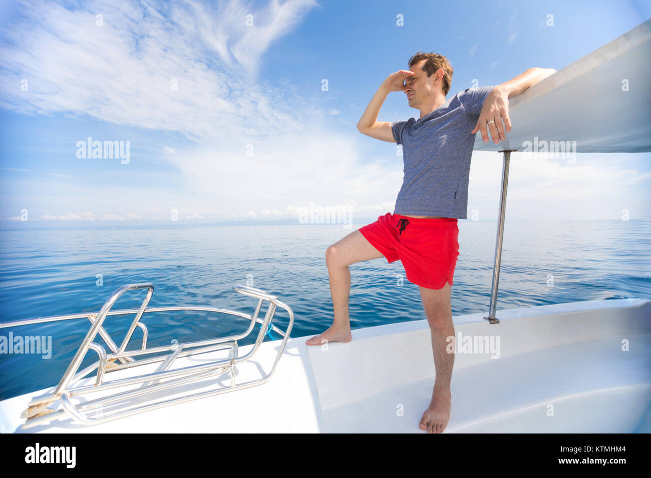 Man on luxury white boat speeding at open blue sea Stock Photo - Alamy