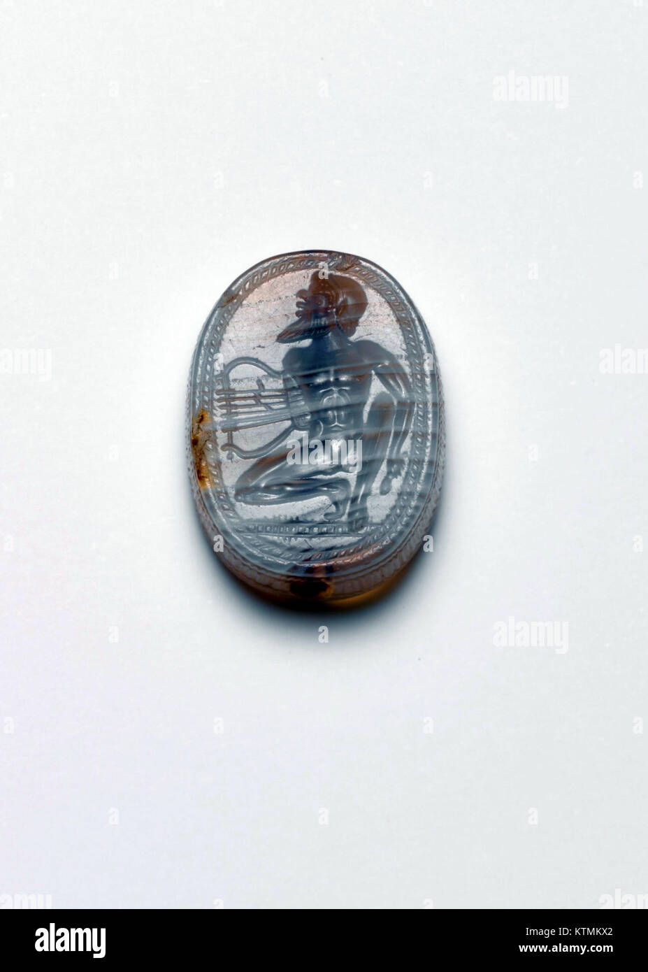 This image shows a banded agate scaraboid from the Metropolitan Museum of Art (MET DP119644). The scaraboid is a form of ancient jewelry or amulet, often used in the ancient world for decorative or symbolic purposes. Stock Photo