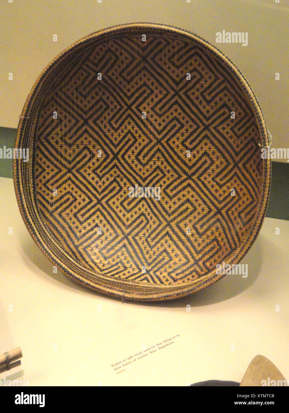 This image depicts a split reed basket created by the Wapishana people ...