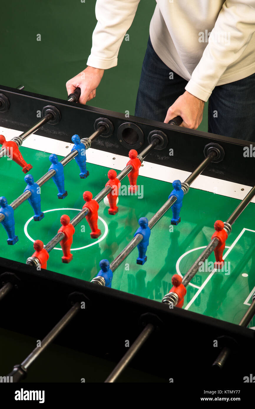 Man playing football table game Stock Photo Alamy
