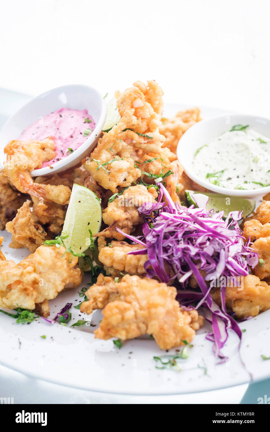 gourmet calamari tempura squid with tzatziki and pickled beetroot sauce meal Stock Photo