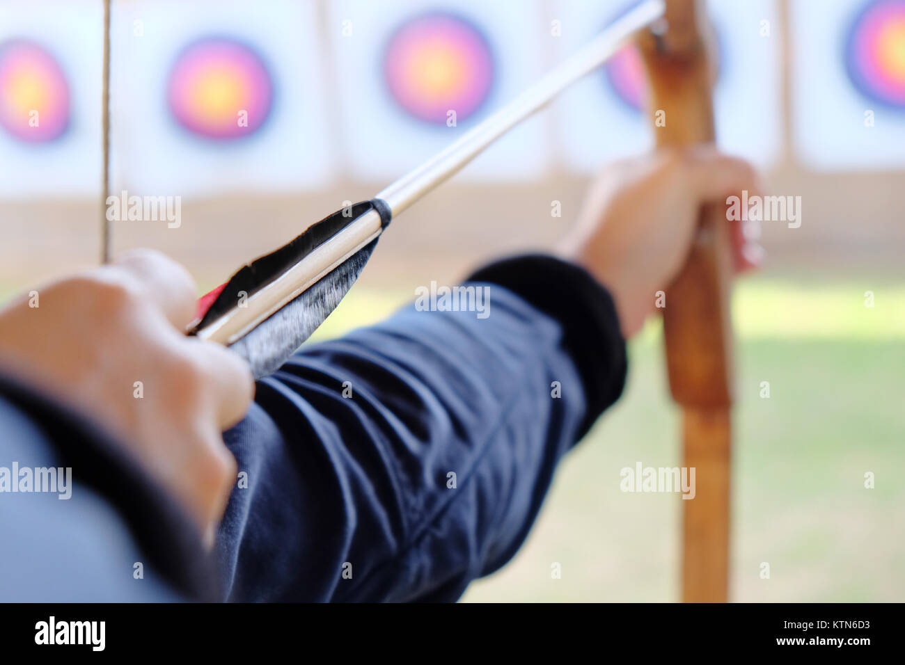 Archer holds his bow aiming at a target Stock Photo - Alamy