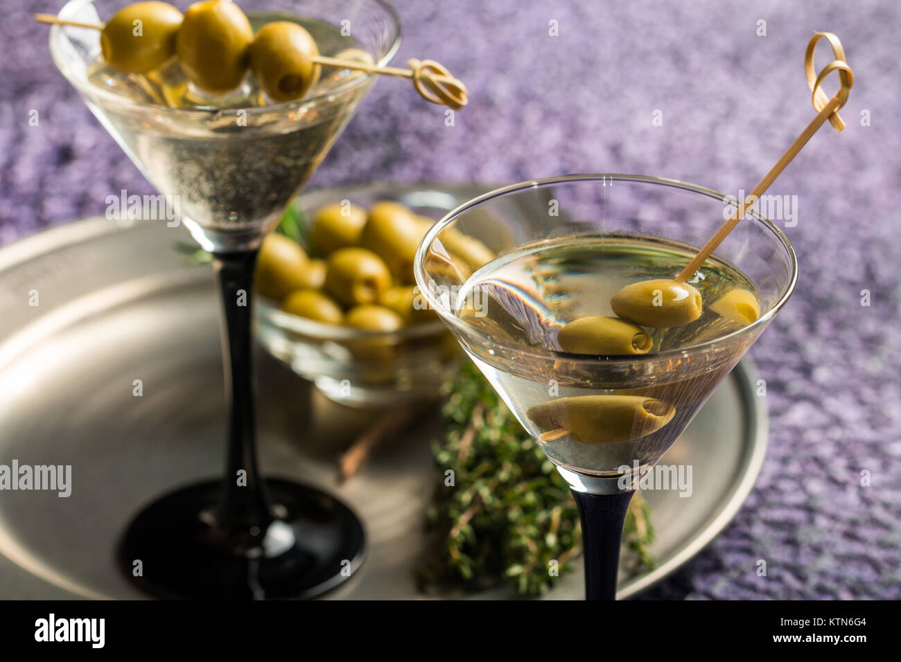 Two glasses of Dry Martini, classic cocktail with olives, vodka and gin