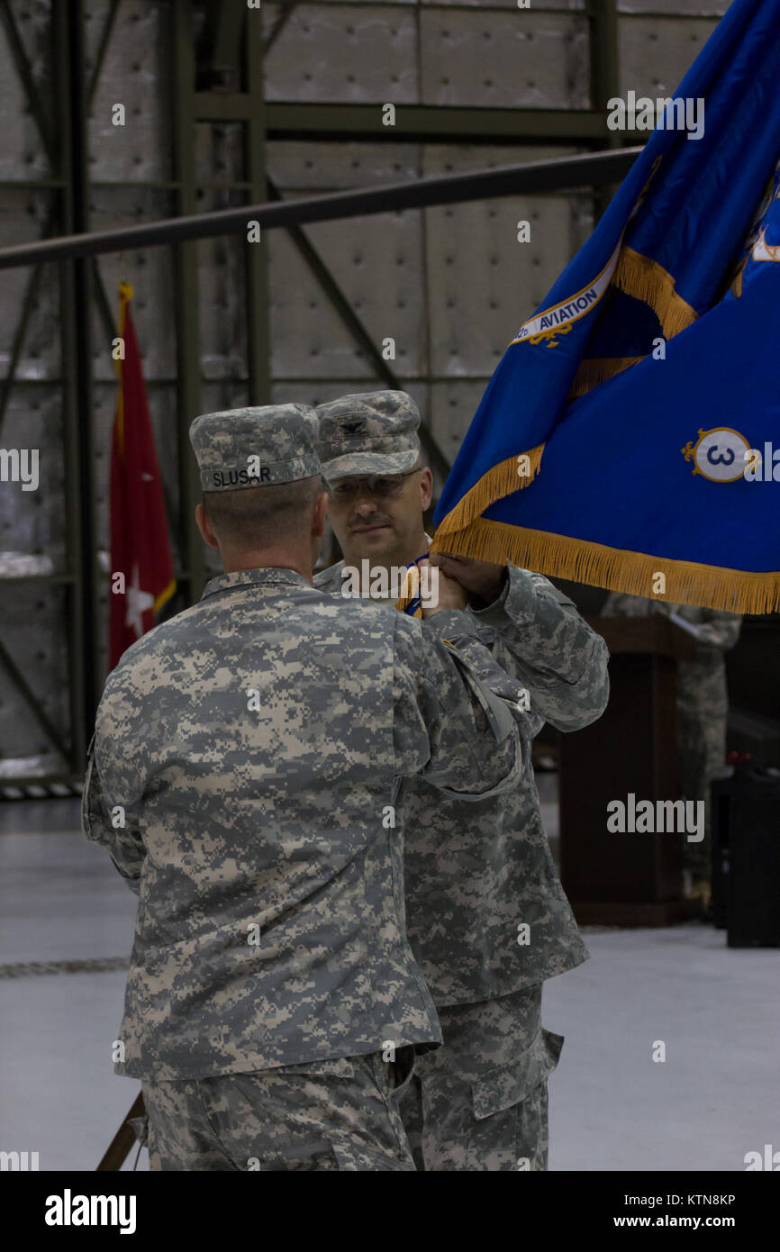 LATHAM, NY -- Col. Mark Stryker, Brigade Commander of the 42nd Combat Aviation Brigade, receives the Battalion guidon from the outgoing commander of the 3-142nd Assault Helicopter Battalion during the Changing of Command of the Battalion from Lt. Col. Mark Slusar to Lt. Col. Jeffery Baker  on 7 September, 2012. Stock Photo