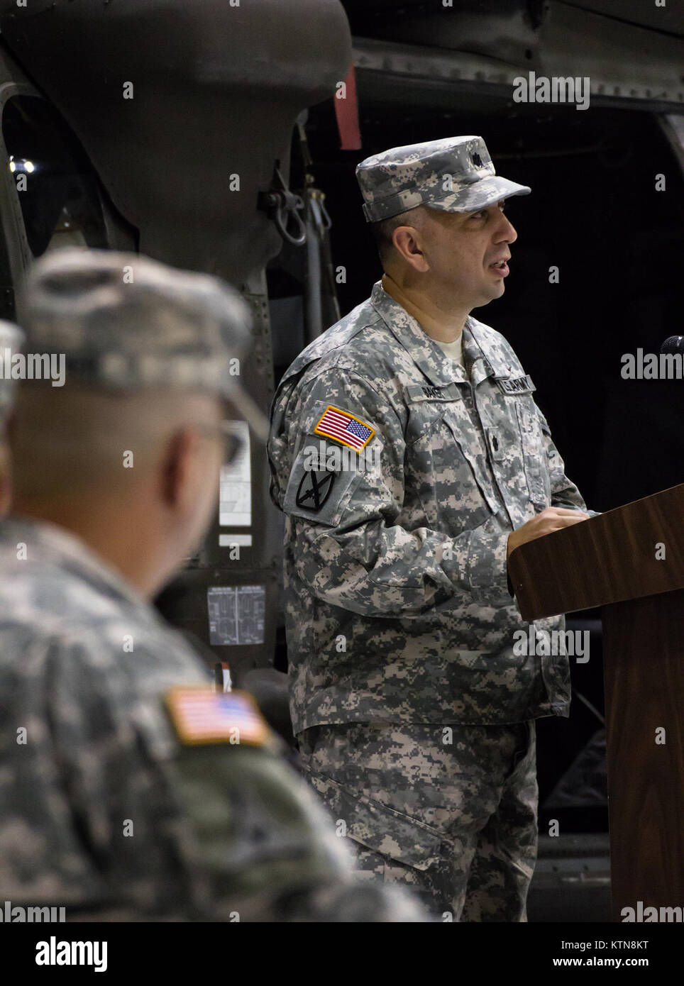 LATHAM, NY -- Lt. Col. Jeffery Baker, the new Battalion Commander of the 3-142nd Assault Helicopter Battalion, addresses his new unit as Col. Mark Stryker, Brigade Commander of the 42nd Combat Aviation Brigade, watches on, 7 September, 2012. Stock Photo