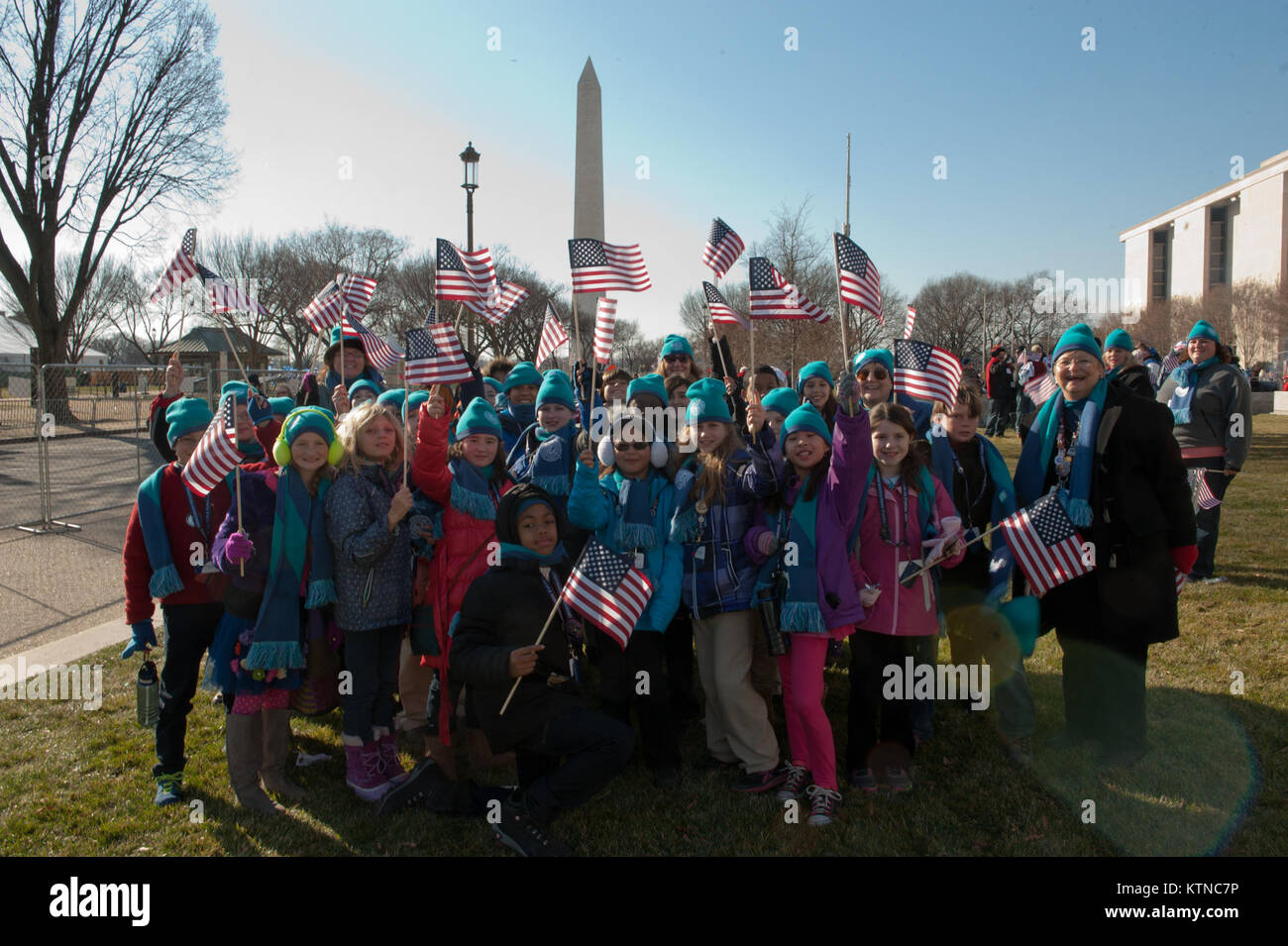 WASHINGTON, D.C. — – A group of students, from the People to People International Student Ambassador Program, wave Amercian flags in front of the George Washington Monument before heading to the Presidential Inauguration Parade. People To People was founded in 1956 by President Dwight D. Eisenhower with a mission to bridge cultural and political borders through education and exchange, creating global citizens and making the world a better place for future generations.   the 57th Presidential Inauguration was held in Washington D.C. on Monday, January 21, 2013. The Inauguration included the Pre Stock Photo