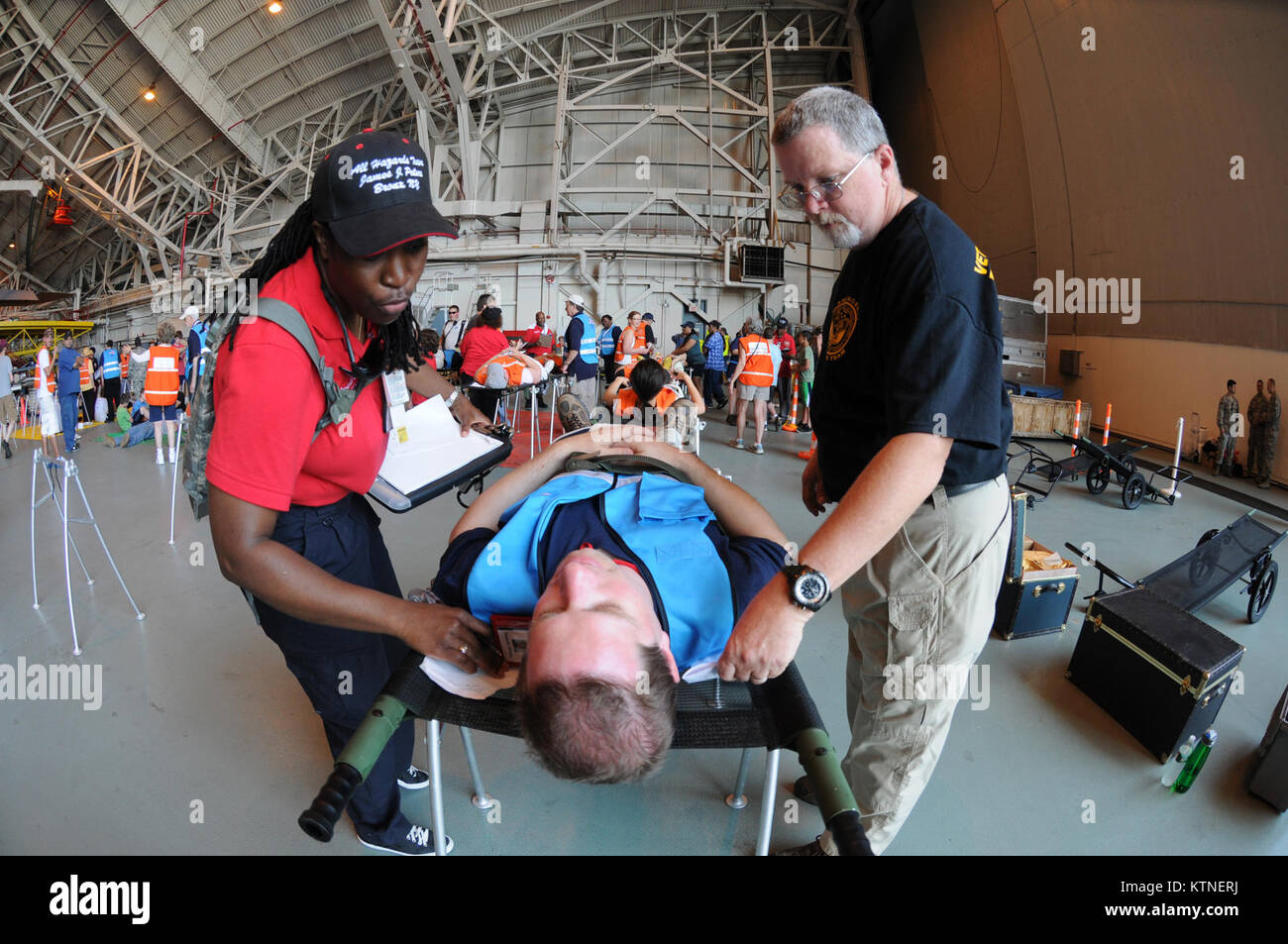 Emergency services personnel administer triage to a simulated patient
