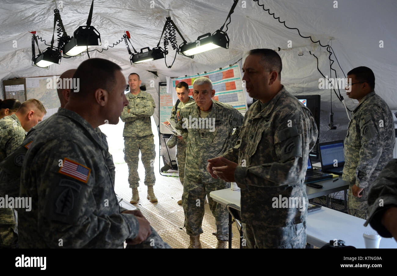 On Aug 18th 2013, Major General Harry E. Miller, Commanding General of the 42d Infantry Division, New York Army National Guard visited Soldiers of the 42nd CAB and 642 ASB during their Pre-Mobilization training being held at Fort Drum. MG Miller visited the soldiers at the various stations such as first aid, Commo, Land Nav and other Warrior Tasks as part of the PMT. MG Miller was also briefed by the Commander of the 3-142 Assault Helicopter Battalion, LTC Jeffrey Baker and his staff on current support operations the Battalion is providing during the PMT as well as future training operations Stock Photo
