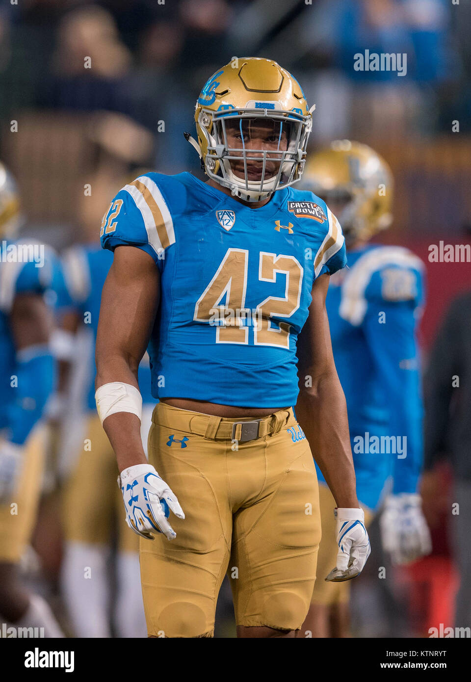 Phoenix, AZ, USA. 26th Dec, 2017. UCLA linebacker (42) Kenny Young, the  last UCLA athlete to ever wear #42 on their jersey, looks for the play call  during the Cactus Bowl game