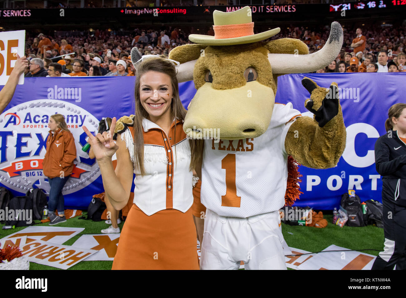 Houston, TX, USA. 27th Dec, 2017. Texas Longhorns mascot Hook 'Em stands with a cheerleader during the 3rd quarter of the Texas Bowl NCAA football game between the Texas Longhorns and the Missouri Tigers at NRG Stadium in Houston, TX. Texas won the game 33 to 16.Trask Smith/CSM/Alamy Live News Stock Photo