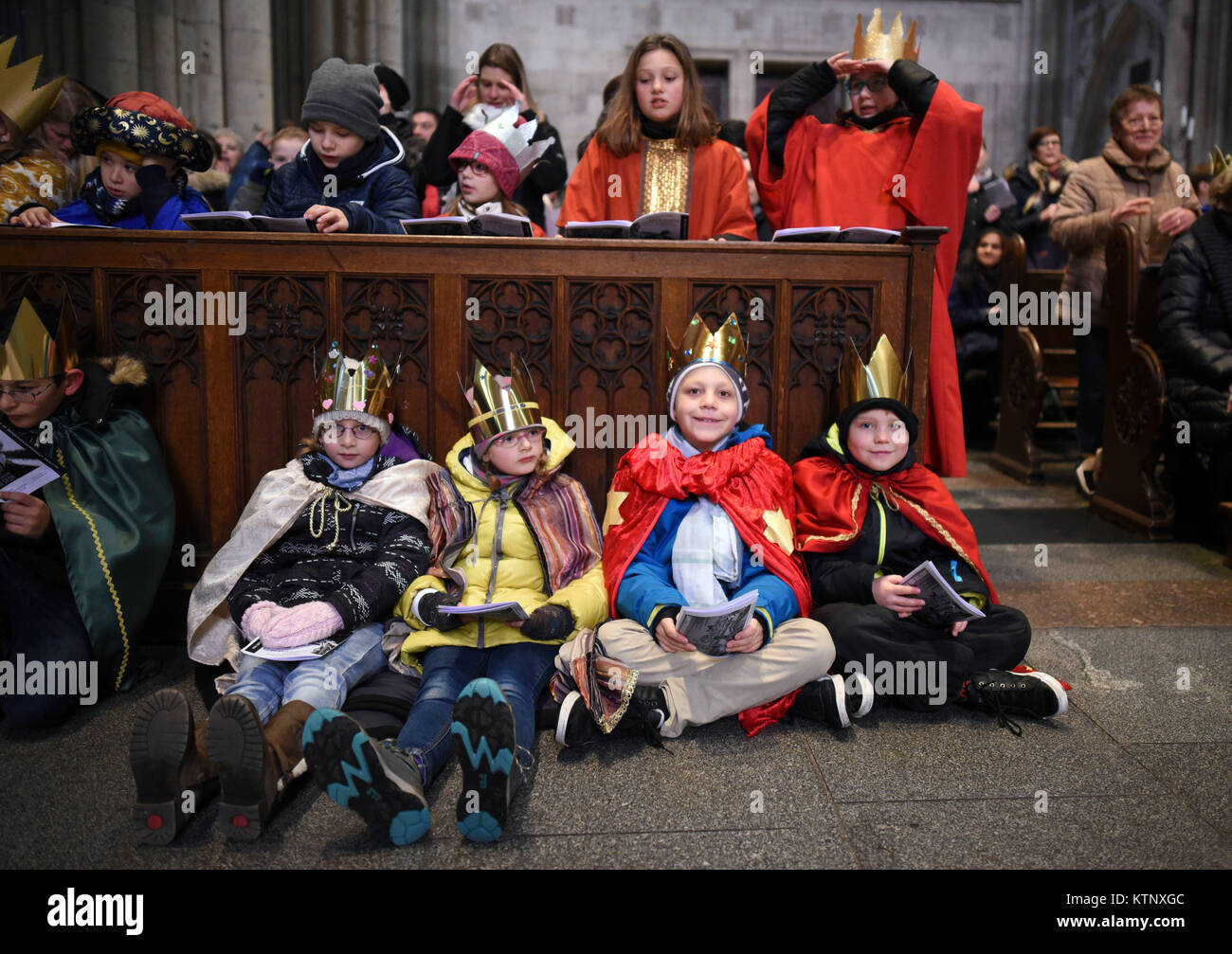 Carol singers sit during their valedictory service in the Cologne
