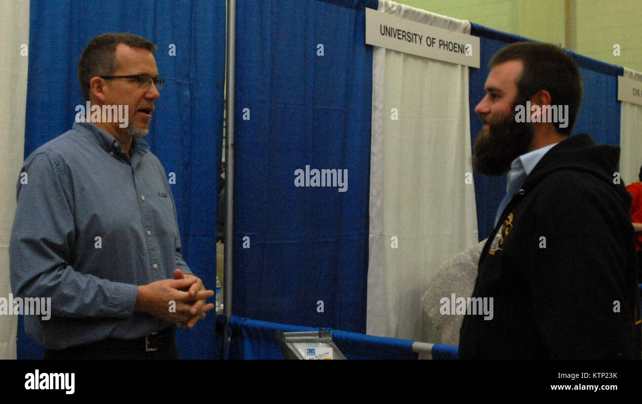 LATHAM, NY – Philip Stenglein, a marketing representative for Sheet Metal Workers’ International Union Local 83 (left), speaks with Afghanistan veteran James Curtin (right) at the U.S. Chamber of Commerce’s “Hiring Our Heroes” job fair held at the New York National Guard armory here on Oct. 16. Over 200 veterans and service members took the opportunity to meet with about 70 potential employers and organizations, including Northwestern Mutual Financial Network, Federal Express, General Electric, Time Warner Cable and National Grid. The New York National Guard has also hosted “Hiring Our Heroes” Stock Photo