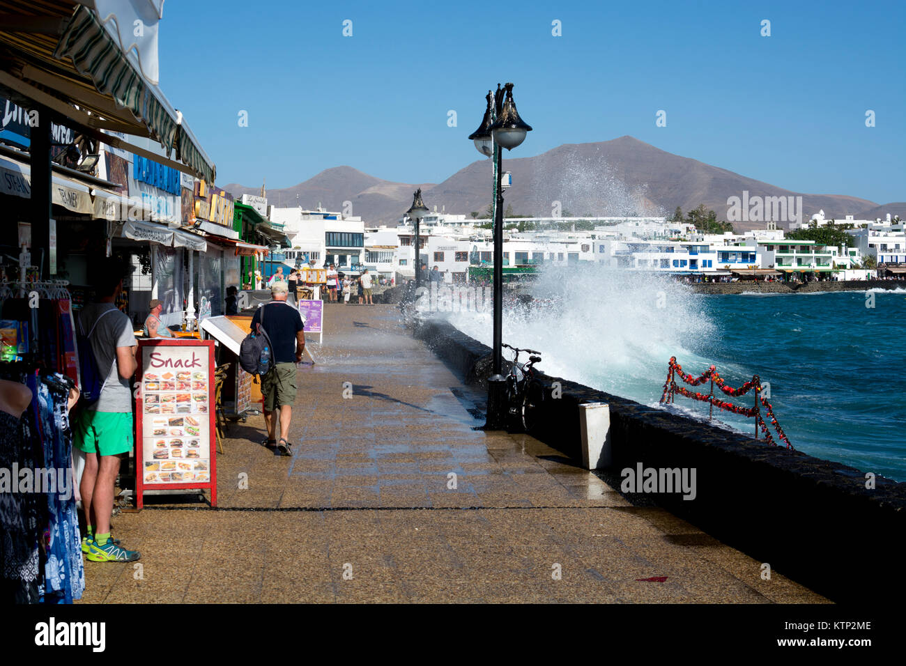 The sea splashing over the sea front at Playa Blanca, Lanzarote, Canary Islands, Spain. Stock Photo