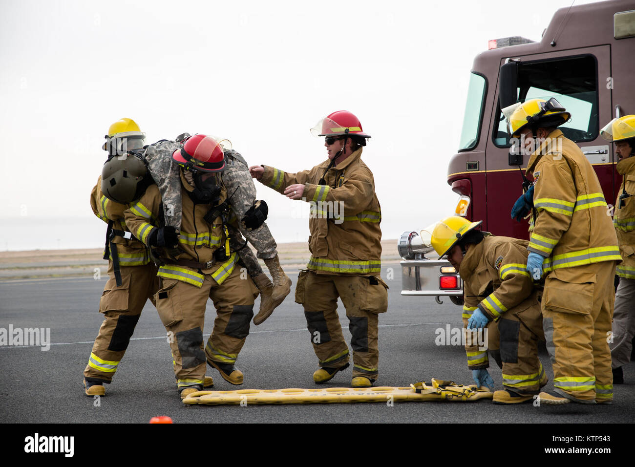 Firefighters and EMTs on Camp Buehring, Kuwait, help rescue two mock