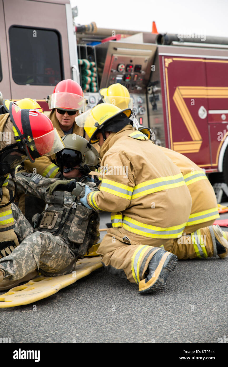 Firefighters and EMTs on Camp Buehring, Kuwait, help rescue two mock