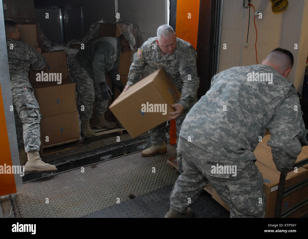 CARMEL, NY -- New York Army National Guard Soldiers Spc. Juan Sanchez (left), Sgt. Christopher Benitez (middle left), Pfc. John Fasanaro (middle right), and Spc. Daniel Bendetti (right) unload boxes of disaster and emergency response starter kits before a session of New York Governor Andrew Cuomo's Citizen Preparedness Corps Training Program at Paladin Center here on March 7. New York National Guard troops gave disaster and emergency training to more than 121 people who attended the event. The program is designed to give citizens the knowledge and tools to prepare for emergencies and disasters Stock Photo
