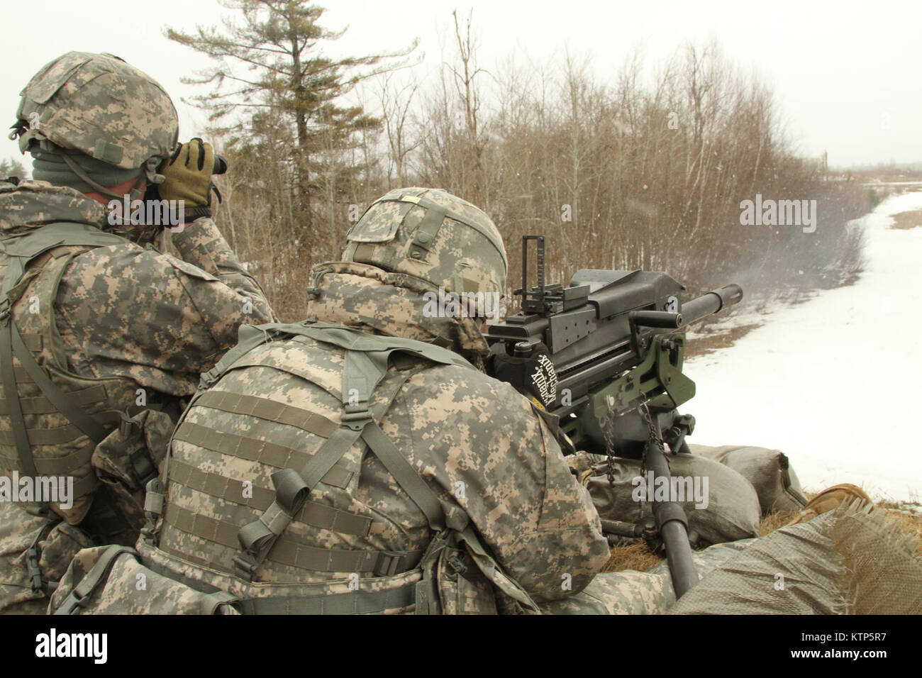Soldiers of the 42nd Infantry Division train on a MK-19 automatic grenade launcher while training in the rain and snow at Fort Drum, N.Y. April 5. Stock Photo