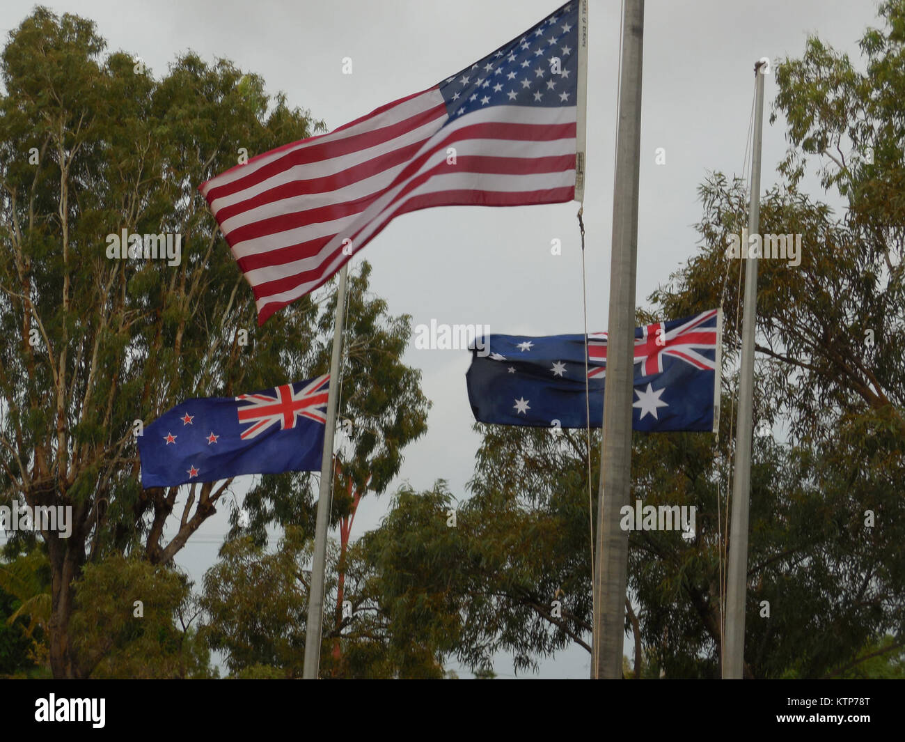 EXMOUTH, Western Australia-- The American flag flies with those of Australia and New Zealand during ANZAC Day celebrations here on April 25 because of the presence of New York Air National Guard Airmen assigned to the 107th Civil Engineer Squadron. The members of the 107th Airlift Wing, based at Niagara Falls Air Reserve Station, were in Australia building a new facility at the H.E. Holt Naval Communications Station which will allow the installation of a new deep space surviallance radar antenna being shipped from Antigua. ANZAC Day is a holiday in Australia and New Zeland and commemorates th Stock Photo