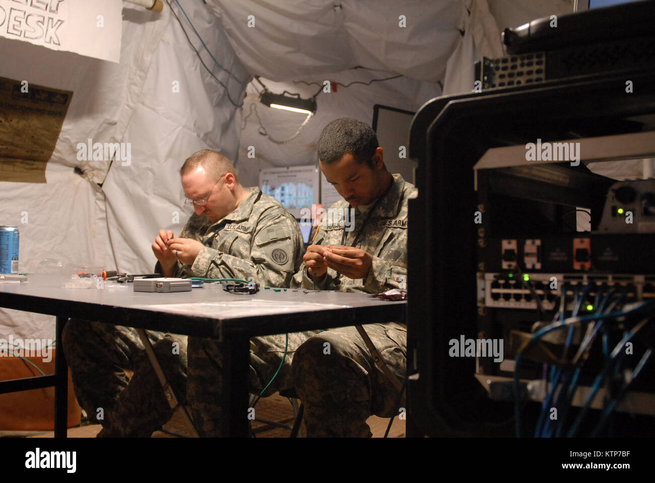 Spc. Trey Hubbard (right), a signal support systems specialist assigned
