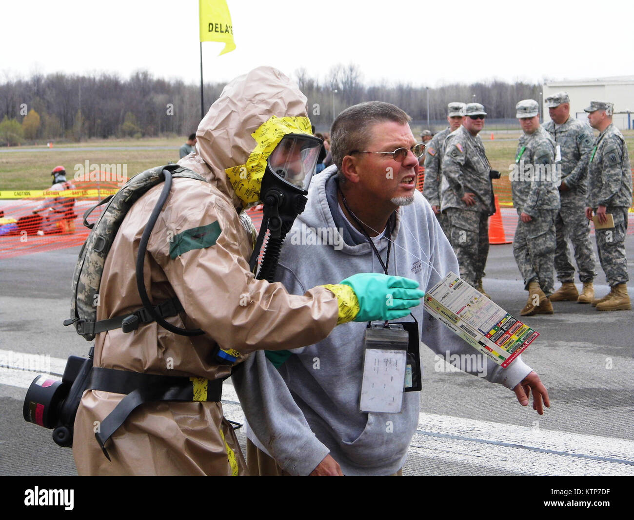 ORISKANY, N.Y. -- A soldier from the decontamination team from the 2nd Squadron, 101 Cavalry, New York Army National Guard guides a victim of a chemical exposure into the ambulatory decontamination tent during a Homeland Response Force exercise at the New York State Preparedness Center here, May 1, 2014 (Photo by 2nd Lt. Roman Pyatetsky). Stock Photo