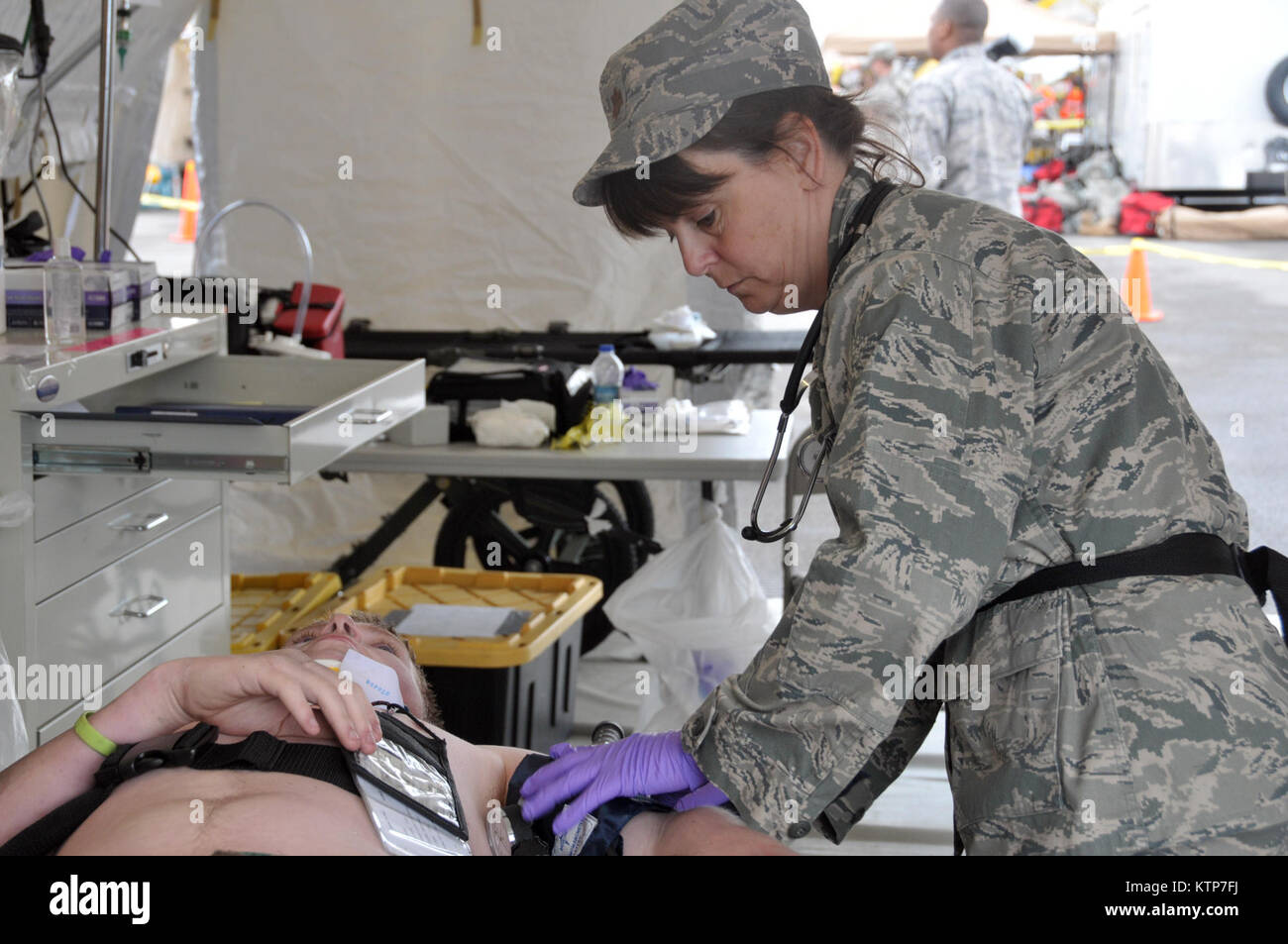 ORISKANY, N.Y. -- Maj. Sharon Westbrook treats a patient during the FEMA II Homeland Response Force validation exercise at the New York State Preparedness Training Center on May 1, 2014.  Westbrook is assigned to the 109th  Medical Group in Scotia, N.Y., and is one of almost 50 New York Air National Guard medics who are participating in the exercise. (U.S. Air National Guard photo by Tech. Sgt. Catharine Schmidt/Released) Stock Photo