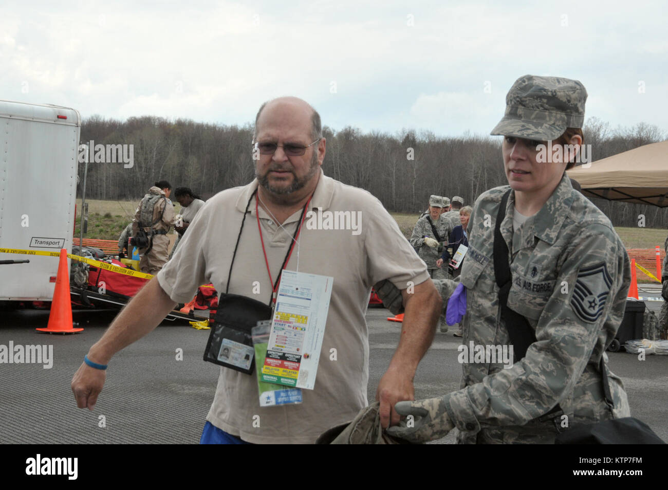 ORISKANY, N.Y. -- Senior Master Sgt. Jacqueline Sweet-McNeill leads a patient to get medical attention during the FEMA II Homeland Response Force validation exercise at the New York State Preparedness Training Center on May 1, 2014. Sweet-McNeill is assigned to the 109th Medical Group in Scotia, N.Y., and is one of almost 50 New York Air National Guard medics who are participating in the exercise. (U.S. Air National Guard photo by Tech. Sgt. Catharine Schmidt/Released) Stock Photo