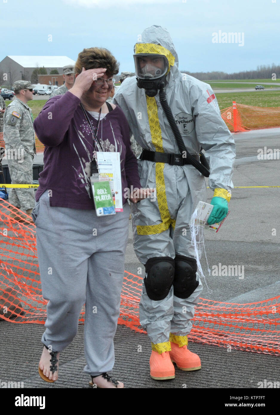 ORISKANY, N.Y. -- Staff Sgt. Lorenzo Rodriguez leads a patient to get medical help after triagining her in the &quot;hot zone&quot; during the FEMA II Homeland Response Force validation exercise at the New York State Preparedness Training Center on May 1, 2014. Lorenzo is assigned to the 109th Medical Group at Stratton Air National Guard Base, Scotia, N.Y., and is one of almost 50 New York Air National Guard medics who are participating in the exercise. (U.S. Air National Guard photo by Tech. Sgt. Catharine Schmidt/Released) Stock Photo