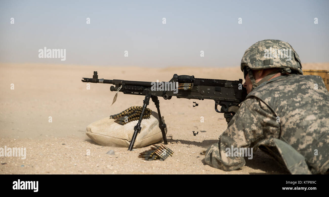 Soldiers from 3rd Battalion, 238th General Support Aviation Battalion (GSAB), and 3rd Battalion, 142nd Assault Helicopter Battalion (AHB), shoot the first phase of aerial gunnery with a 240B machine gun on June 3, 2014, near Camp Buehring, Kuwait.  Once refreshed with the weapon system on the ground the aviators of the battalions will conduct aerial gunnery training and qualifications with their UH-60 Black Hawks later on in the month.  The GSAB and AHB, from the Michigan and New York Army National Guards, respectively, are both deployed to Kuwait under the 42nd Combat Aviation Brigade in supp Stock Photo