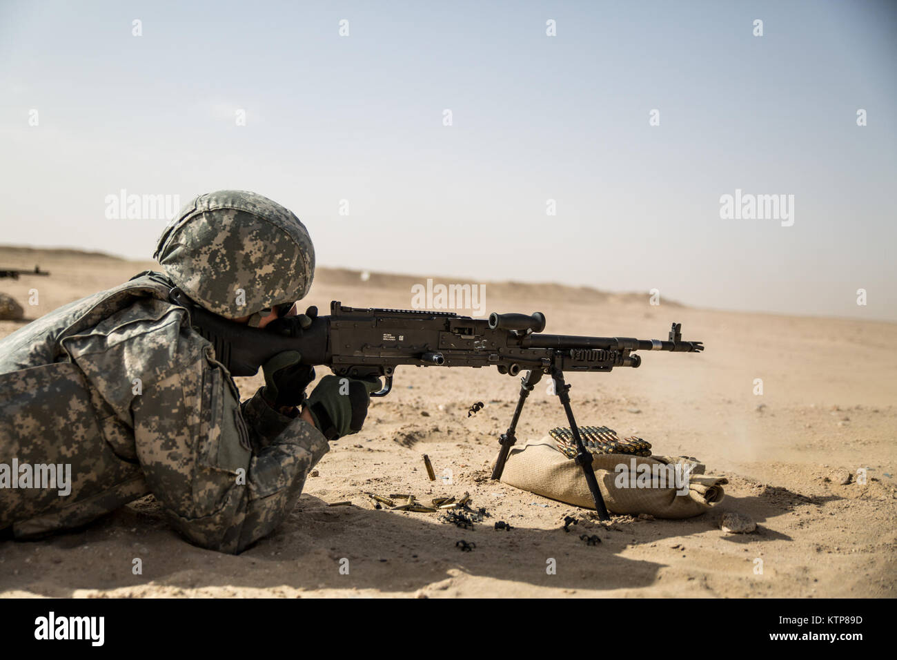 Soldiers from 3rd Battalion, 238th General Support Aviation Battalion (GSAB), and 3rd Battalion, 142nd Assault Helicopter Battalion (AHB), shoot the first phase of aerial gunnery with a 240B machine gun on June 3, 2014, near Camp Buehring, Kuwait.  Once refreshed with the weapon system on the ground the aviators of the battalions will conduct aerial gunnery training and qualifications with their UH-60 Black Hawks later on in the month.  The GSAB and AHB, from the Michigan and New York Army National Guards, respectively, are both deployed to Kuwait under the 42nd Combat Aviation Brigade in supp Stock Photo