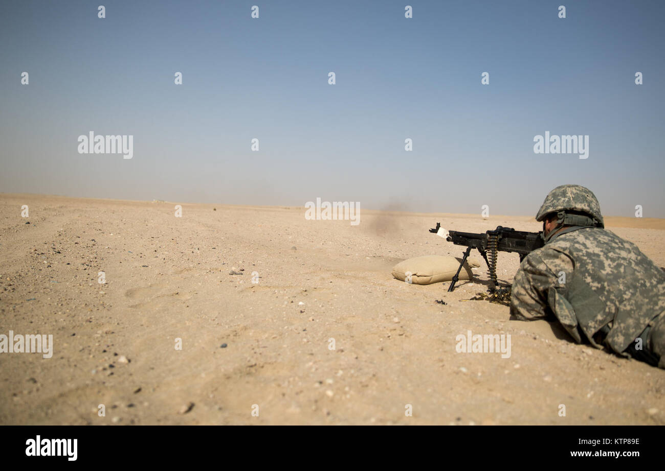 Soldiers from 3rd Battalion, 238th General Support Aviation Battalion (GSAB), and 3rd Battalion, 142nd Assault Helicopter Battalion (AHB), shoot the first phase of aerial gunnery with a 240B machine gun on June 3, 2014, near Camp Buehring, Kuwait.  Once refreshed with the weapon system on the ground the aviators of the battalions will conduct aerial gunnery training and qualifications with their UH-60 Black Hawks later on in the month.  The GSAB and AHB, from the Michigan and New York Army National Guards, respectively, are both deployed to Kuwait under the 42nd Combat Aviation Brigade in supp Stock Photo