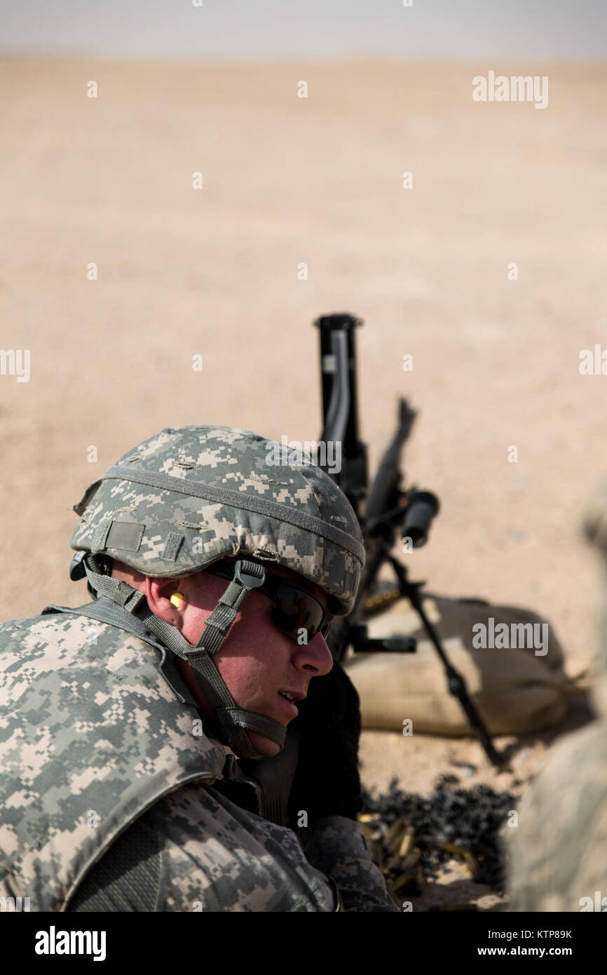 Soldiers from 3rd Battalion, 238th General Support Aviation Battalion (GSAB), and 3rd Battalion, 142nd Assault Helicopter Battalion (AHB), shoot the first phase of aerial gunnery with a 240B machine gun on June 3, 2014, near Camp Buehring, Kuwait.  Once refreshed with the weapon system on the ground the aviators of the battalions will conduct aerial gunnery training and qualifications with their UH-60 Black Hawks later on in the month.  The GSAB and AHB, from the Michigan and New York Army National Guards, respectively, are both deployed to Kuwait under the 42nd Combat Aviation Brigade in supp Stock Photo