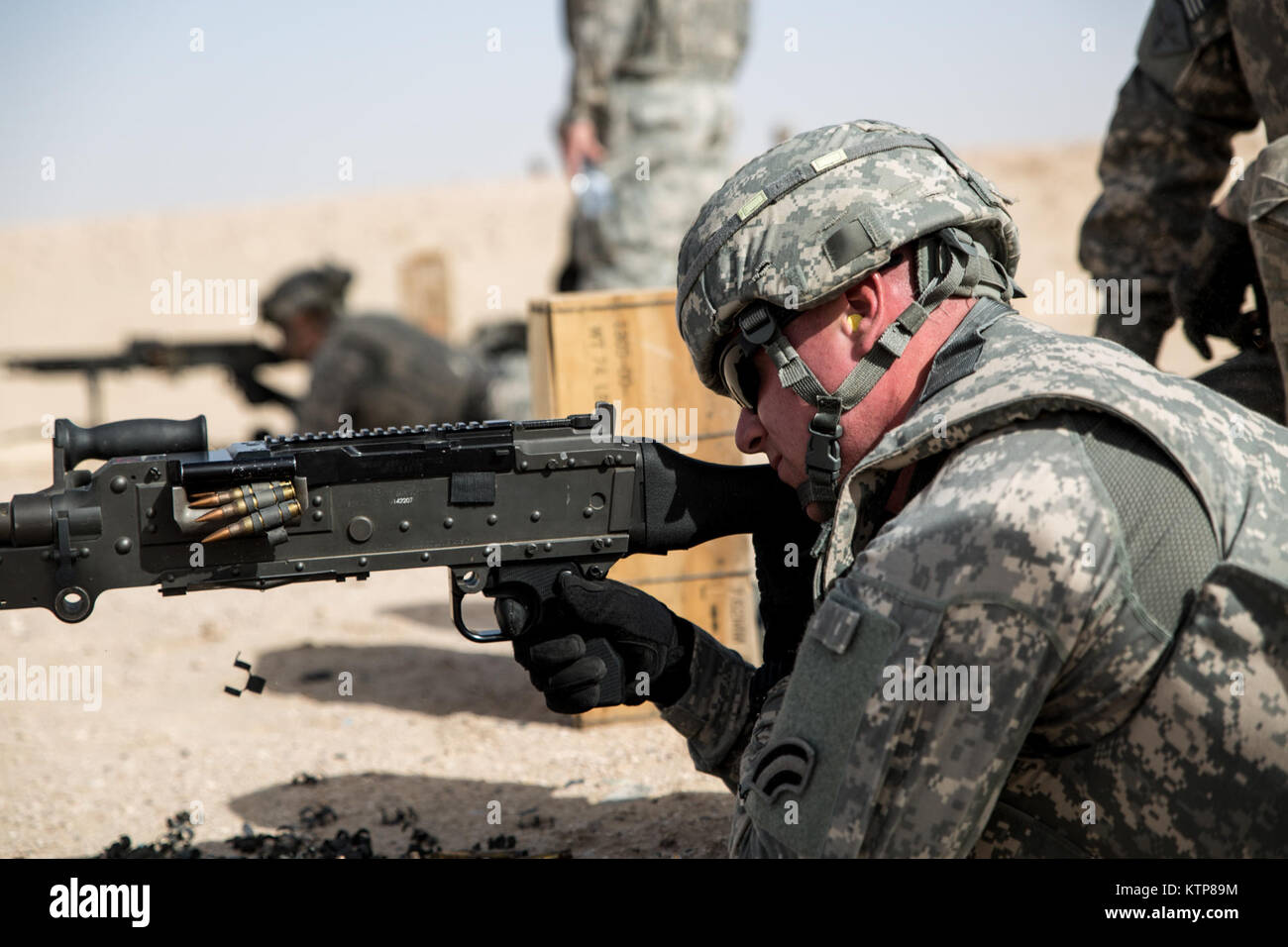 Soldiers from 3rd Battalion, 238th General Support Aviation Battalion (GSAB), and 3rd Battalion, 142nd Assault Helicopter Battalion (AHB), shoot the first phase of aerial gunnery with a 240B machine gun on June 3, 2014, near Camp Buehring, Kuwait.  Once refreshed with the weapon system on the ground the aviators of the battalions will conduct aerial gunnery training and qualifications with their UH-60 Black Hawks later on in the month.  The GSAB and AHB, from the Michigan and New York Army National Guards, respectively, are both deployed to Kuwait under the 42nd Combat Aviation Brigade in supp Stock Photo