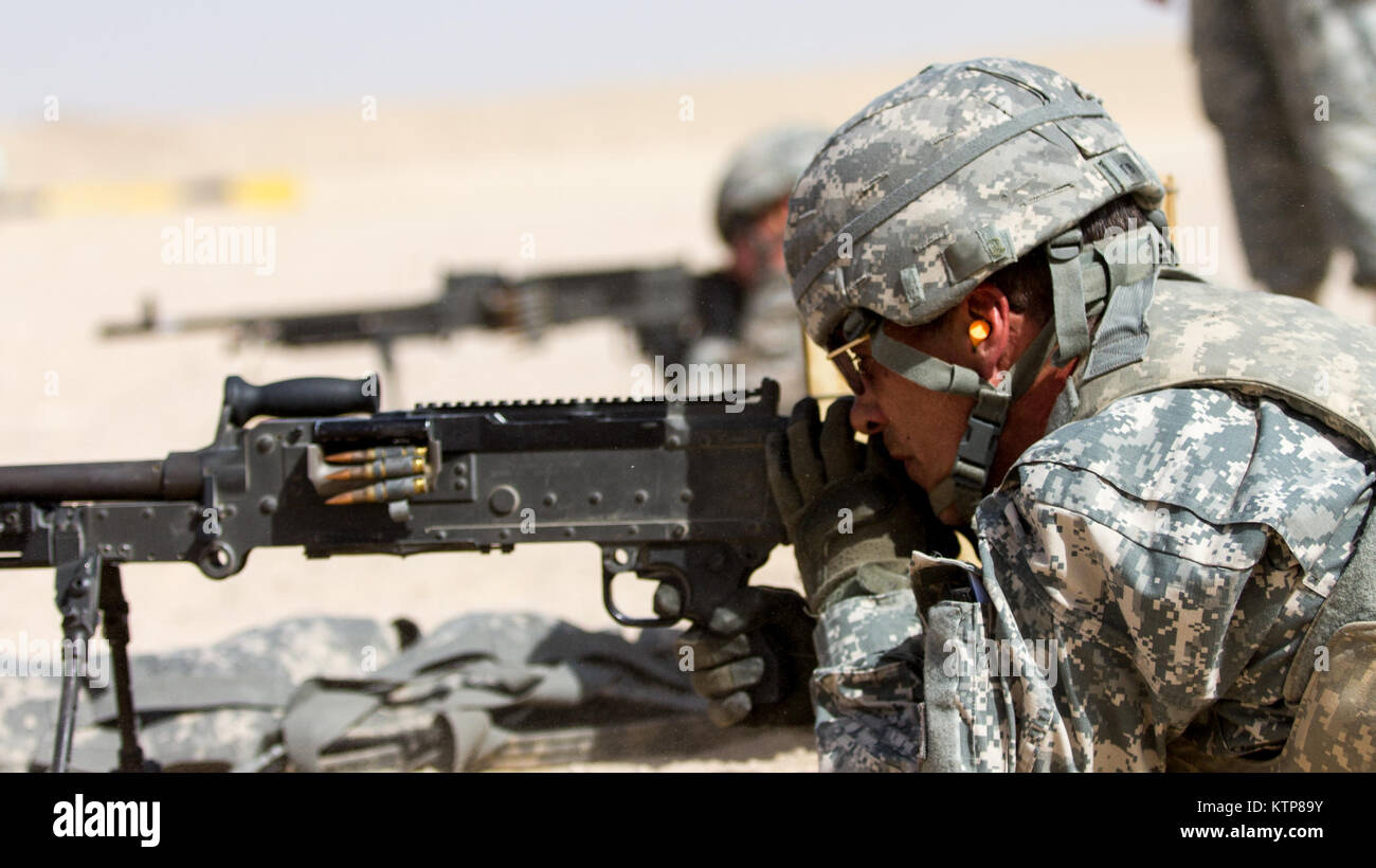 Soldiers from 3rd Battalion, 238th General Support Aviation Battalion (GSAB), and 3rd Battalion, 142nd Assault Helicopter Battalion (AHB), shoot the first phase of aerial gunnery with a 240B machine gun on June 3, 2014, near Camp Buehring, Kuwait.  Once refreshed with the weapon system on the ground the aviators of the battalions will conduct aerial gunnery training and qualifications with their UH-60 Black Hawks later on in the month.  The GSAB and AHB, from the Michigan and New York Army National Guards, respectively, are both deployed to Kuwait under the 42nd Combat Aviation Brigade in supp Stock Photo