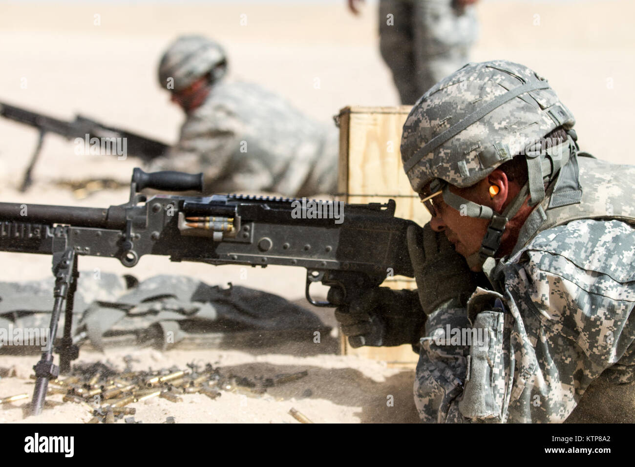 Soldiers from 3rd Battalion, 238th General Support Aviation Battalion (GSAB), and 3rd Battalion, 142nd Assault Helicopter Battalion (AHB), shoot the first phase of aerial gunnery with a 240B machine gun on June 3, 2014, near Camp Buehring, Kuwait.  Once refreshed with the weapon system on the ground the aviators of the battalions will conduct aerial gunnery training and qualifications with their UH-60 Black Hawks later on in the month.  The GSAB and AHB, from the Michigan and New York Army National Guards, respectively, are both deployed to Kuwait under the 42nd Combat Aviation Brigade in supp Stock Photo