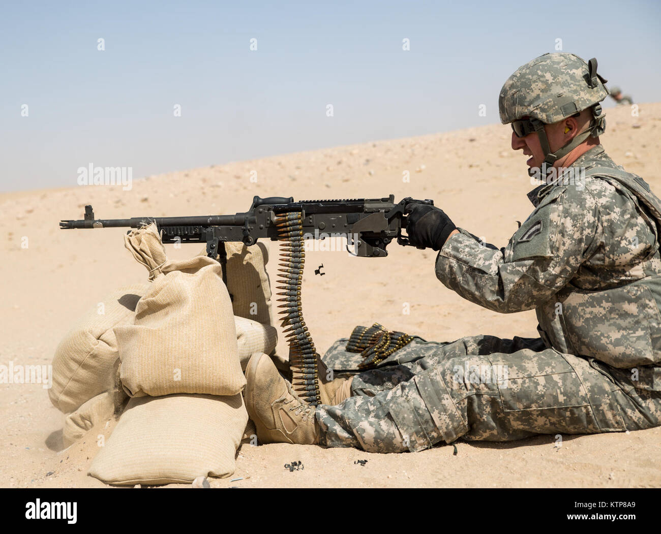 Soldiers from 3rd Battalion, 238th General Support Aviation Battalion (GSAB), and 3rd Battalion, 142nd Assault Helicopter Battalion (AHB), shoot the first phase of aerial gunnery with a 240B machine gun on June 3, 2014, near Camp Buehring, Kuwait.  Once refreshed with the weapon system on the ground the aviators of the battalions will conduct aerial gunnery training and qualifications with their UH-60 Black Hawks later on in the month.  The GSAB and AHB, from the Michigan and New York Army National Guards, respectively, are both deployed to Kuwait under the 42nd Combat Aviation Brigade in supp Stock Photo